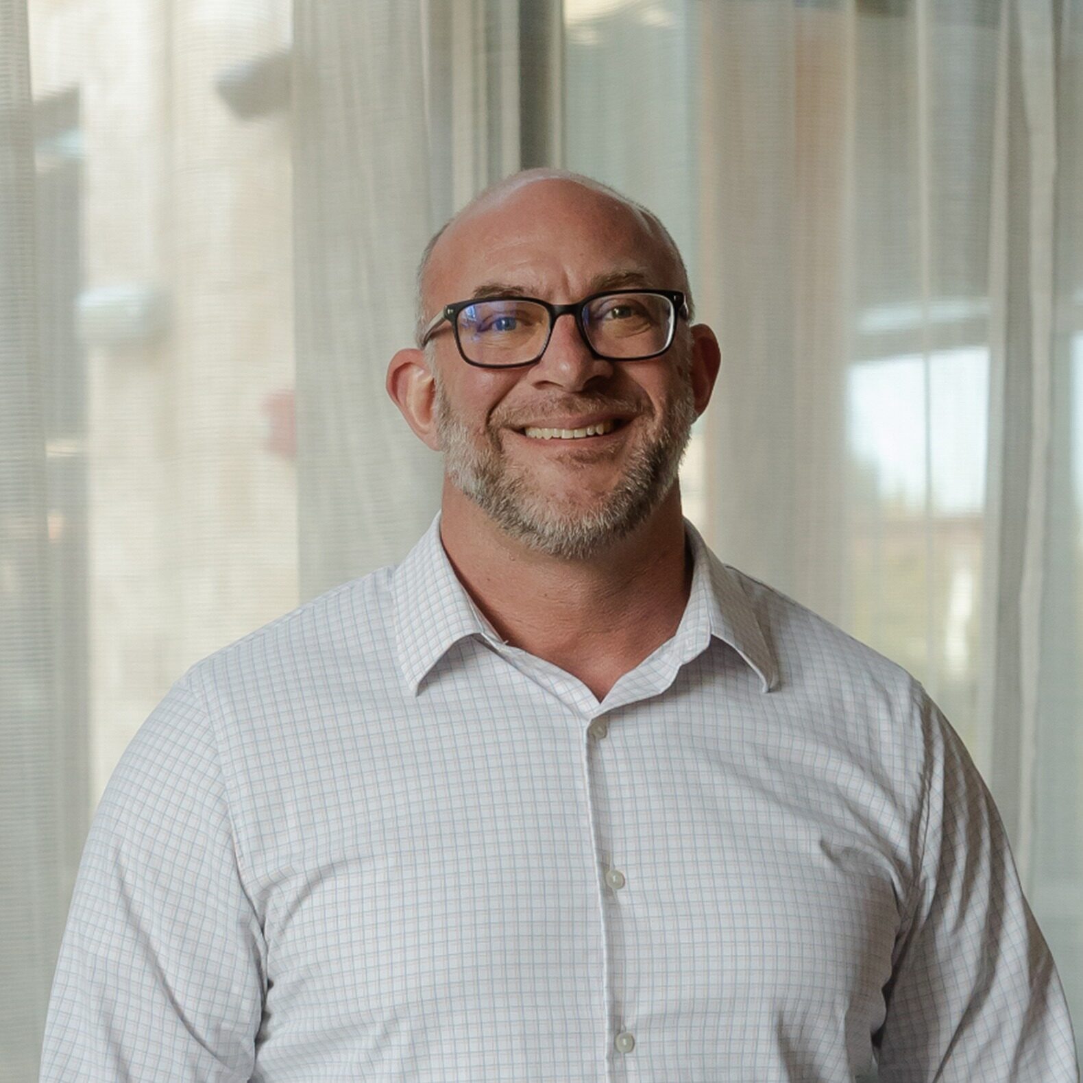 Male orthodontist wearing glasses smiling in office at Walla Walla Orthodontics