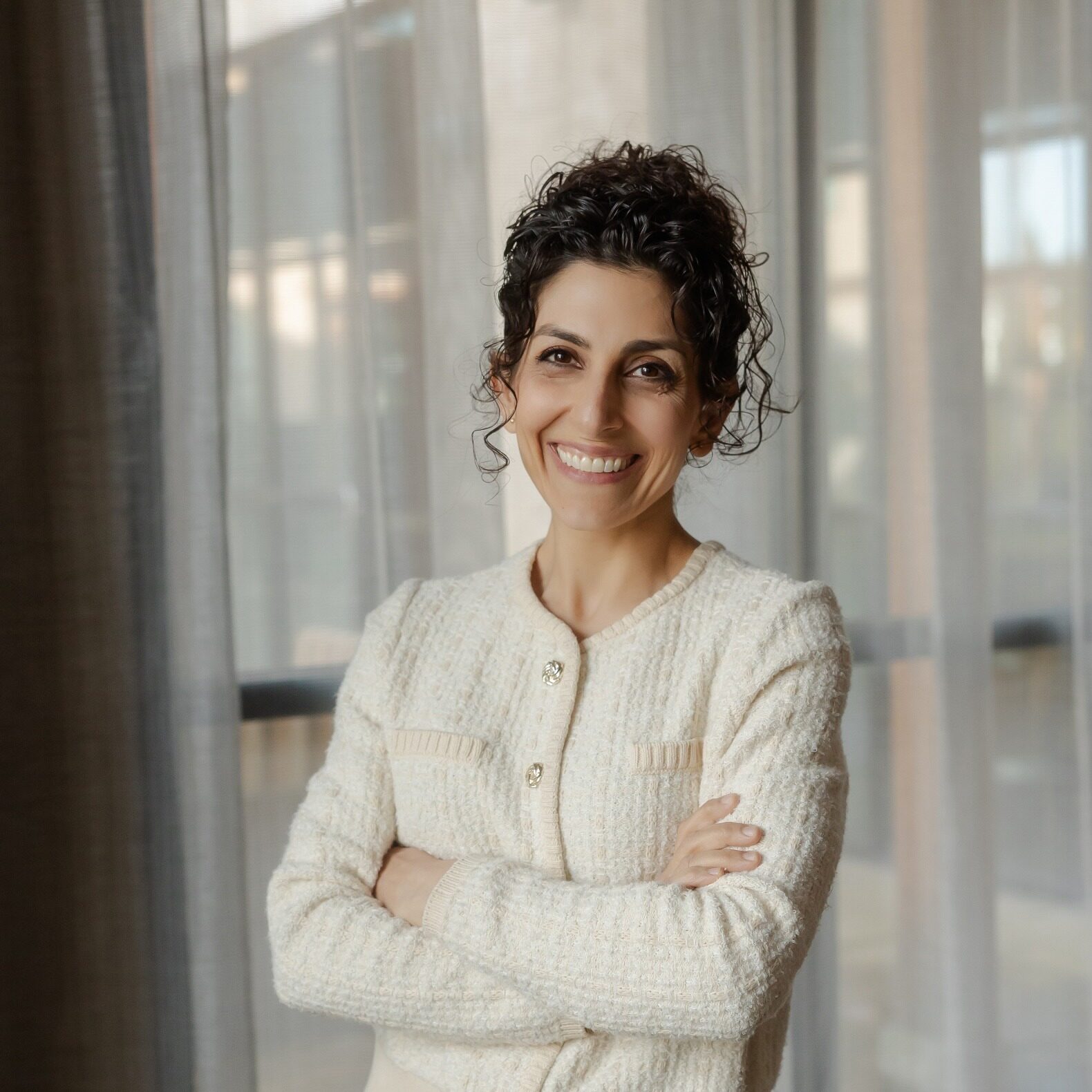 Female orthodontist smiling with arms crossed at Walla Walla Orthodontics office